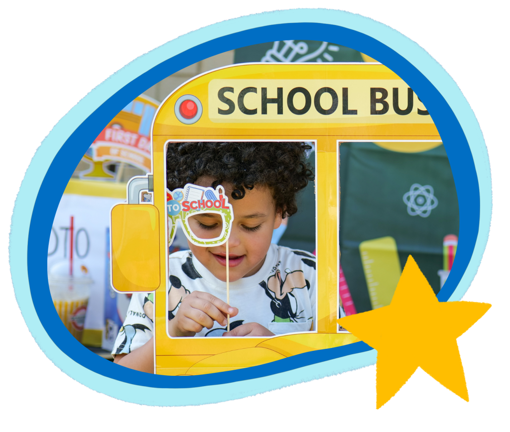 A child is pictured holding a "To School" sign, framed in a yellow school bus cutout.